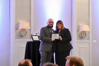 a photograph of Gunnar Kennedy recieving the promising leader award