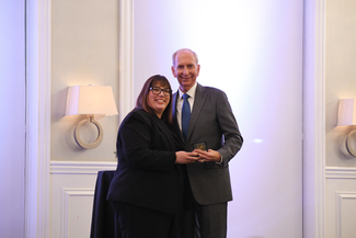 a photograph of Heather Bush presenting an award