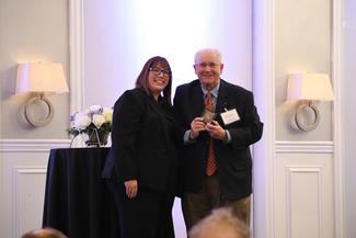 a photograph of Heather Bush presenting an award