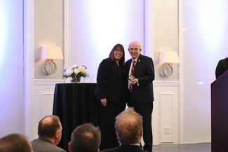 a photograph of Heather Bush presenting an award