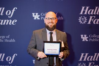 a photograph of Gunnar Kennedy posing with their award