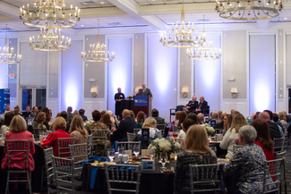 a photograph of someone speaking at the event