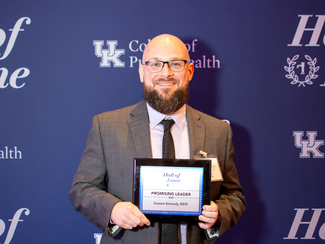 a photograph of Gunnar Kennedy at the Hall of Fame awards in 2025 holding their "promising leader award"