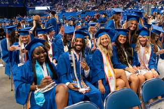 A group of bachelors of public health students at commencement smiling at the camera