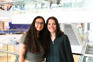 a photograph of two students smiling for the camera at the Gatton Student Center
