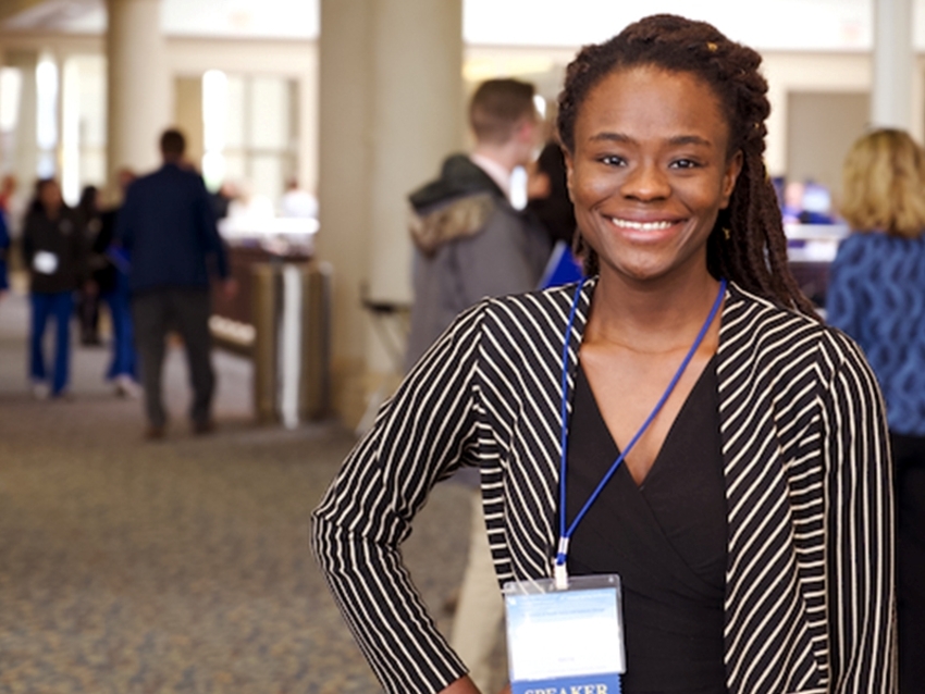 a photograph of a student smiling at the camera in the Student Center