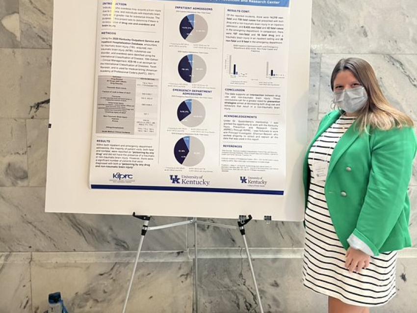 a photograph of Grace Bush next to their poster presentation