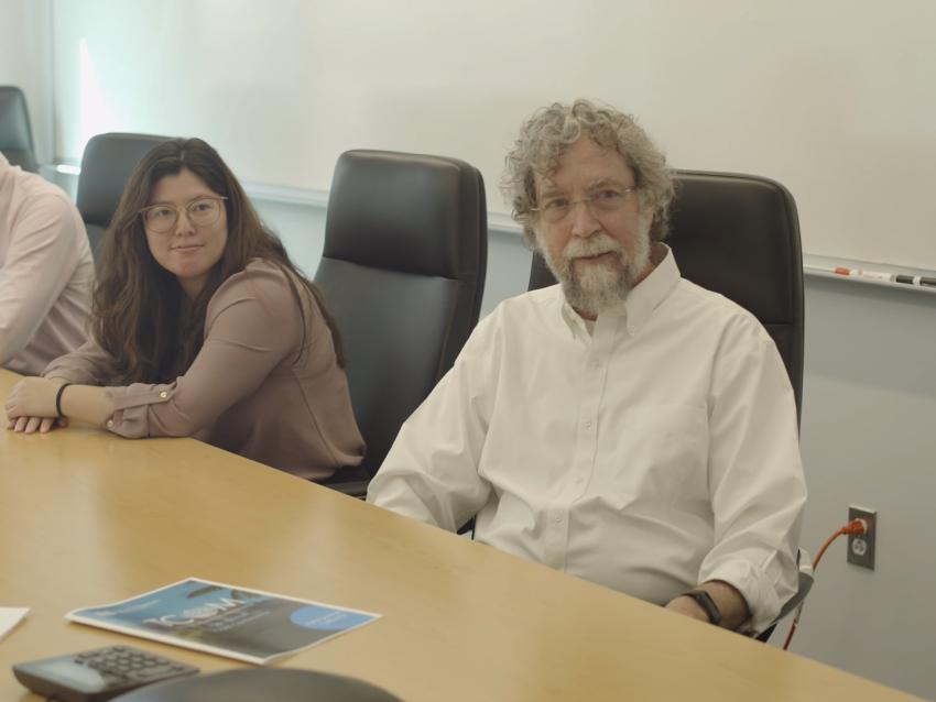 a photograph of John Lyons, Diamond Darling and Brian Turner at a conference table