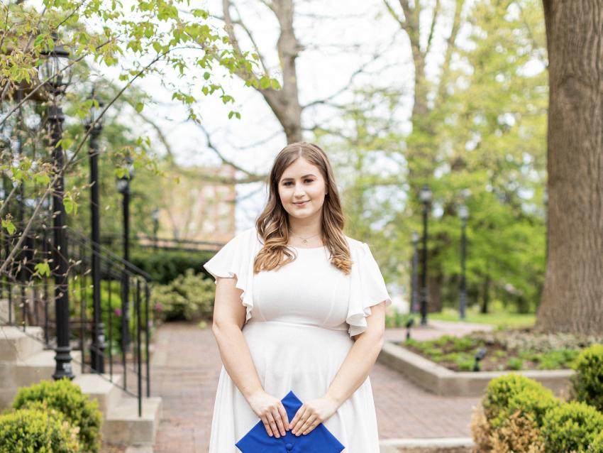 a photograph of Kelsey Gatton posing with her graduation cap