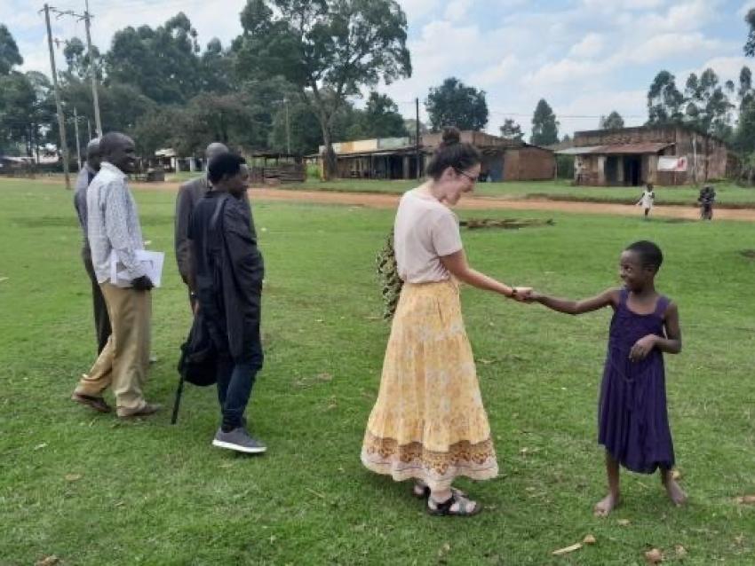 MPH student Jennifer O'Brien greeting a local on the way to check out a borehole in Ndivisi Market