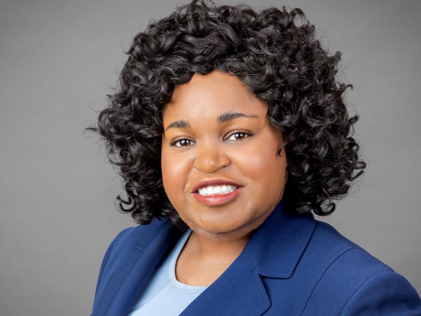 Professional picture of alum, Reynald Davis, wearing a blue blazer