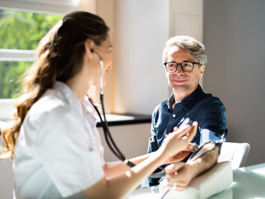 Doctor measuring blood pressure of patient