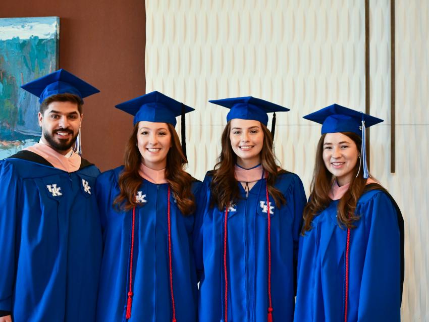 Public health students pictured in graduation regalia