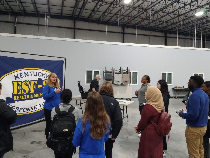 Angela Kick speaking to public health students at the state's operations warehouse