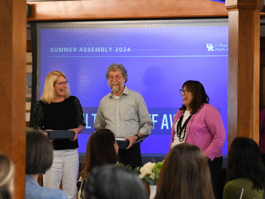 a photograph of CPH faculty getting an award from Heather Bush