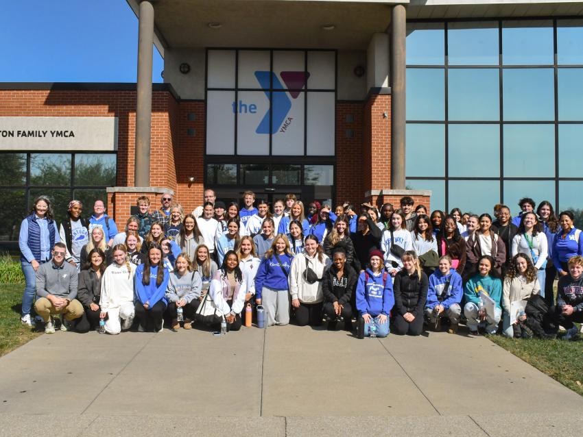 a photograph of College of Public Health students posing outside a YMCA
