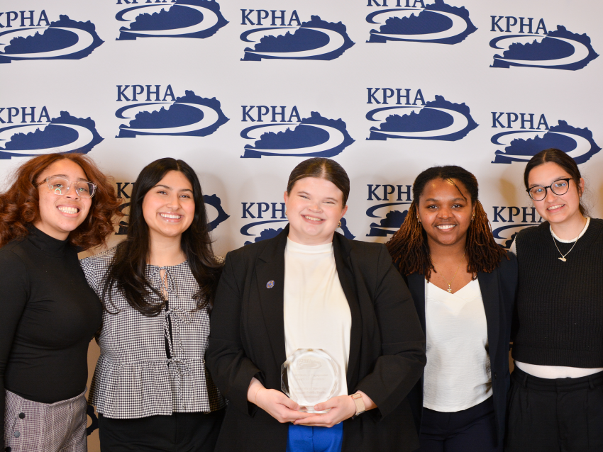 a photograph of the UKSPHA posing with their award