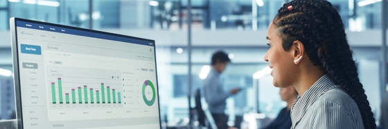 a stock photograph of a person working with data on a computer in an office building