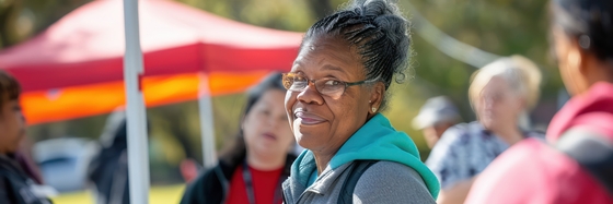 a stock photograph of a woman setting up an outdoor event
