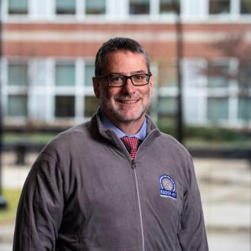 a photograph of Jeffery Talbert posing in their RADOR-KY zip up sweater